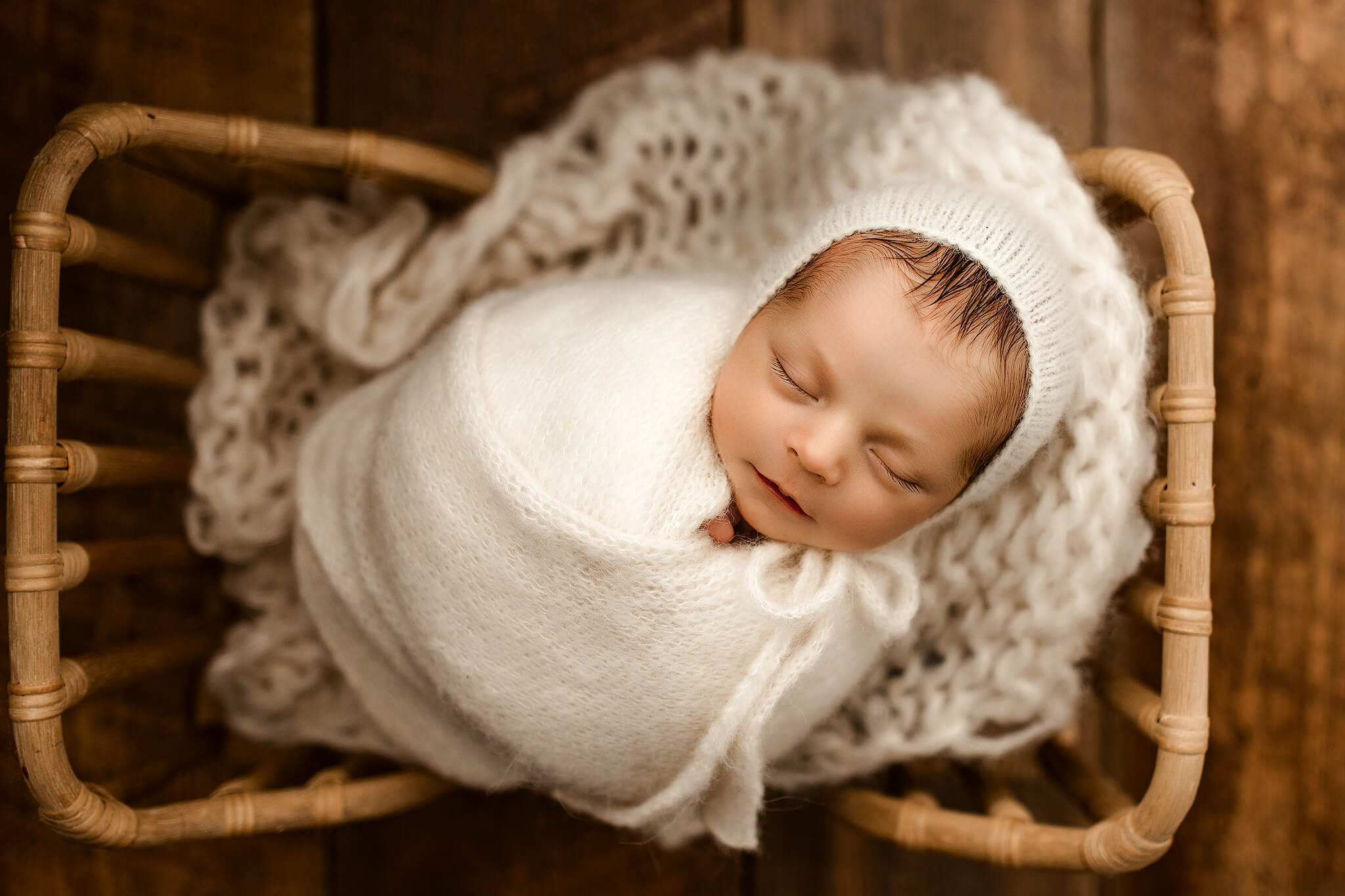 newborn posed in baby prop bed during newborn photography session