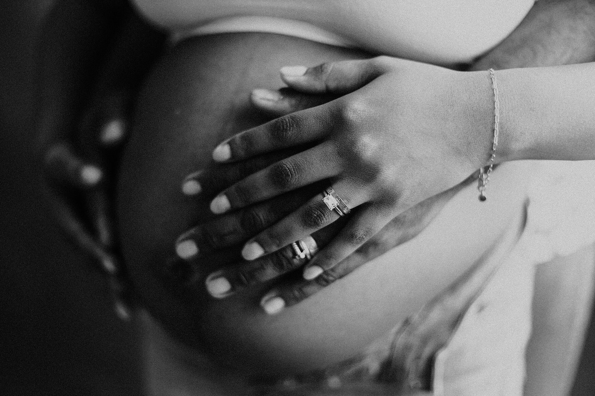 black and white image of atlanta parents holding mom's belly