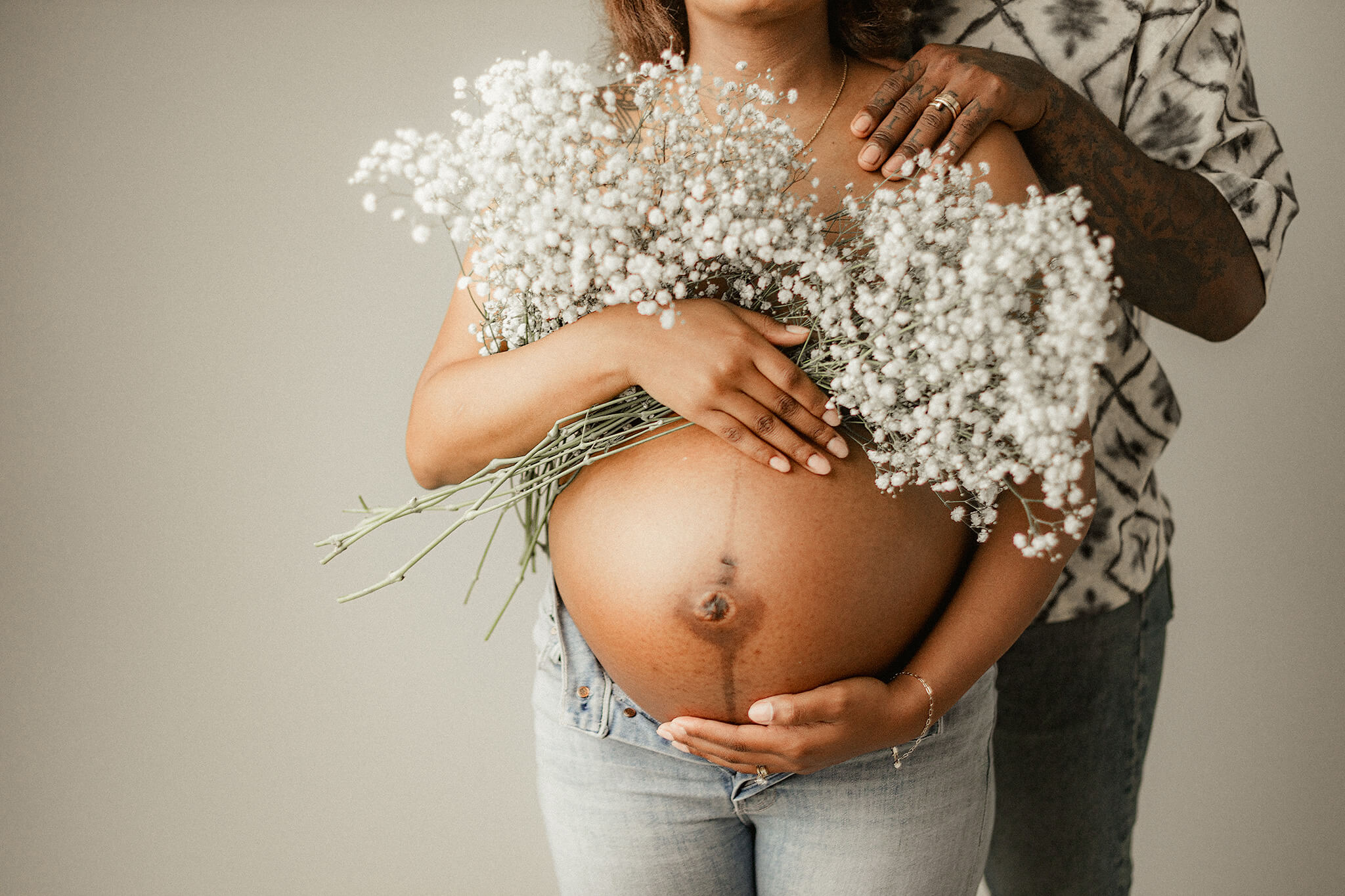 atlanta mother holding belly with flowers