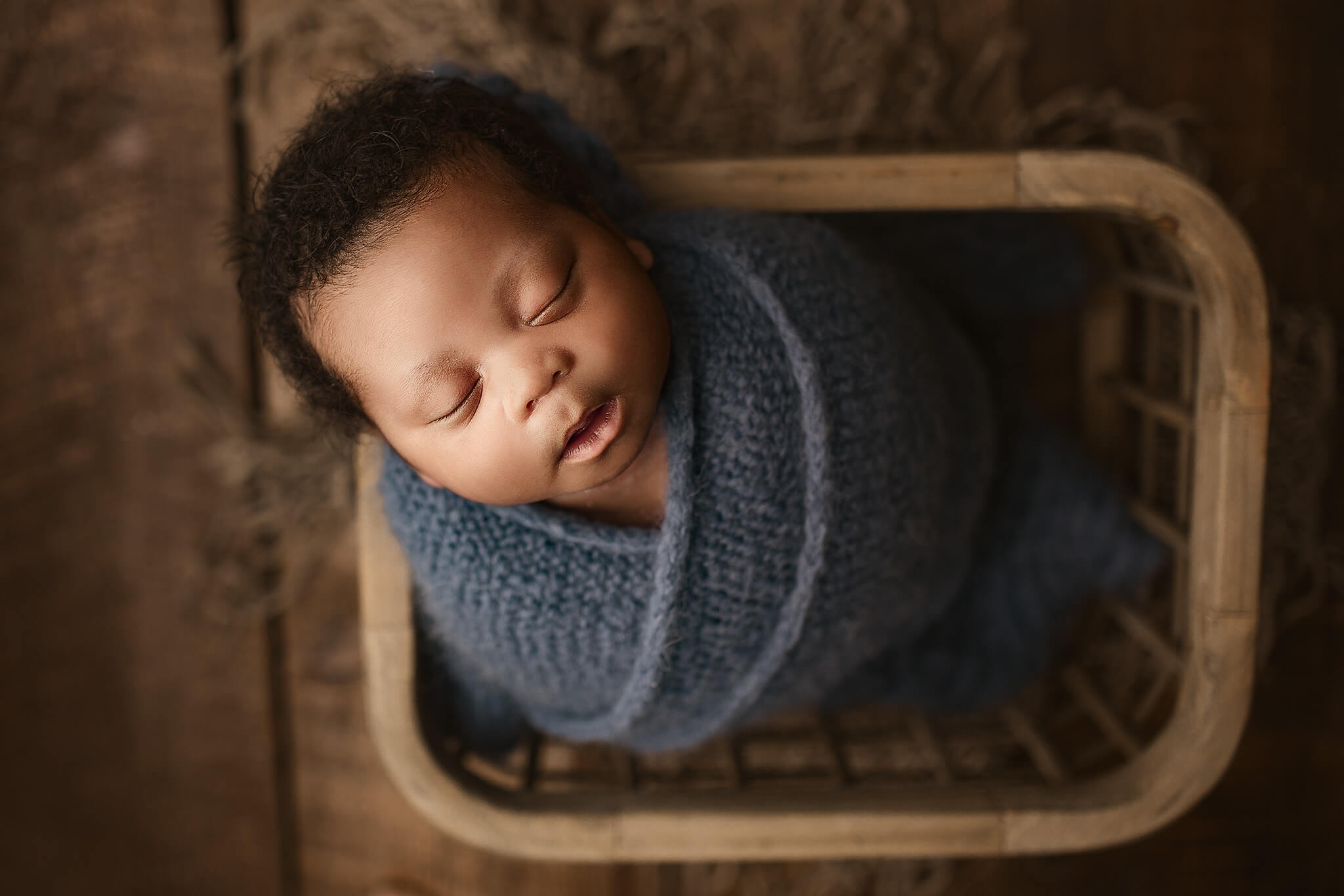 sleeping baby in newborn basket prop